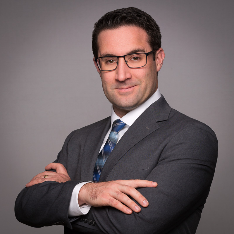 Professional headshot of probate attorney in gray suit and blue tie.